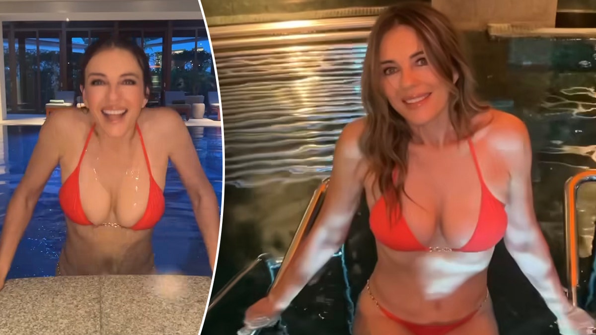 Elizabeth Hurley in a red bikini pushes up to the surface of the pool split she poses on the stairs of the pool