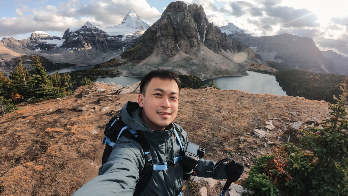 man takes selfie on mountain