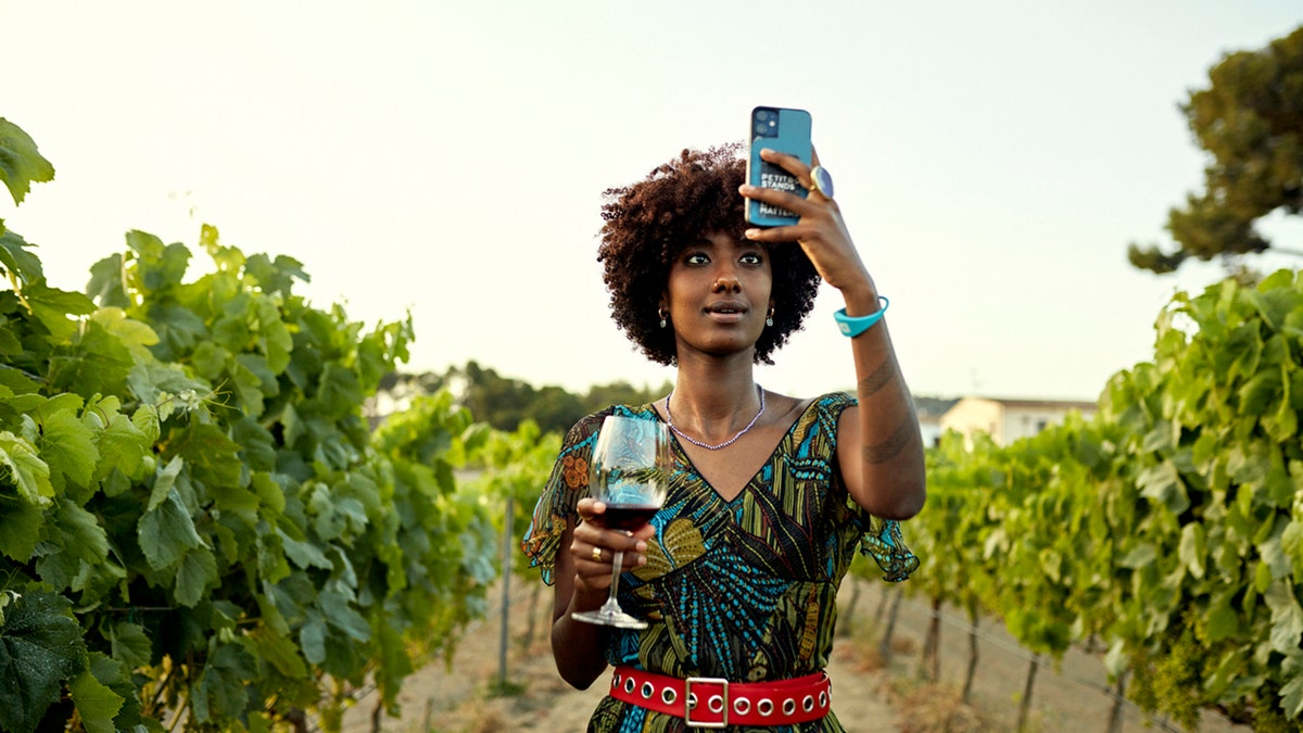 woman takes photo in vineyard