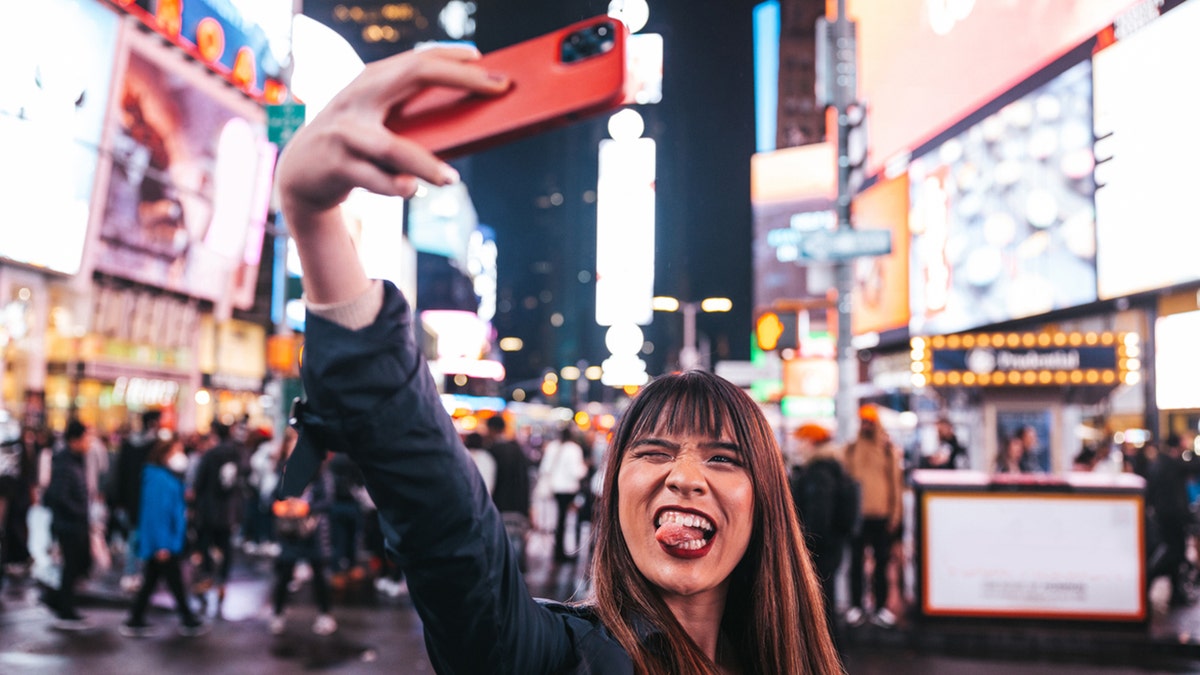 womans take selfie in times square